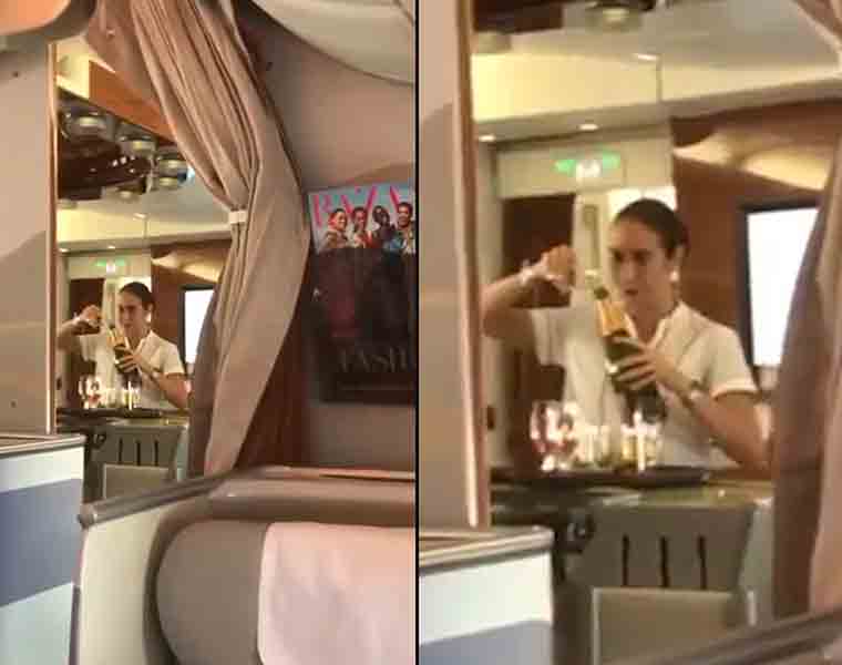 Emirates air hostess caught on cam pouring champagne back in bottle