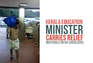 Kerala floods State Education Minister C Raveendranath relief materials shoulders Video