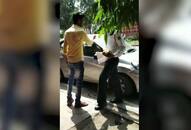 Delhi police traffic cop fine wrongly parked vehicle verbal abuse break phone