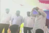 Karnataka Revenue Minister RV Deshpande throws sports kits from a stage to athletes Karwar