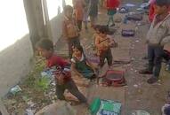 School kids sitting with dogs