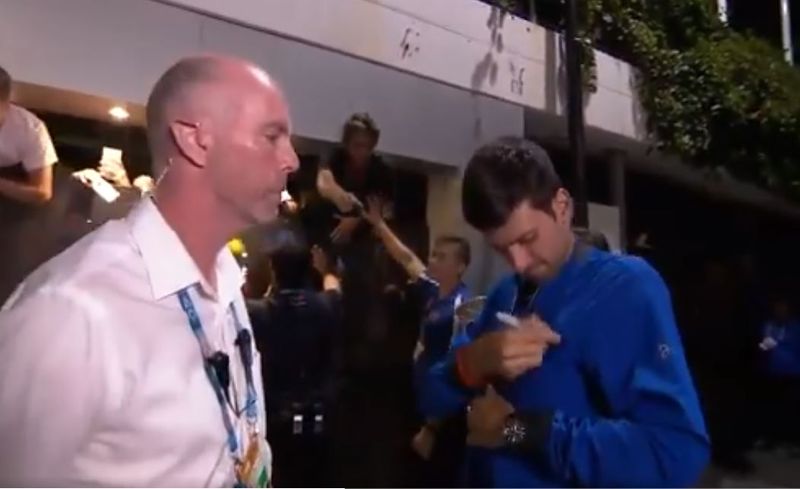 True champion Novak djokovic took off his jacket signed it and gave it to fans