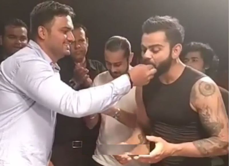 Virat Kohli celebrates his security personnel faizalkhan birthday while on work