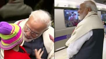 PM Modi takes metro ride ISKCON interacts commuters takes selfies