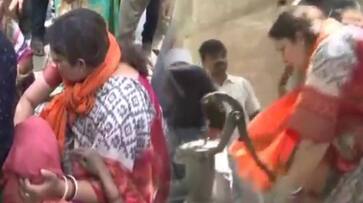 Smriti Irani draws water from handpump in fire-affected  fields in Amethi Purab Dwara village