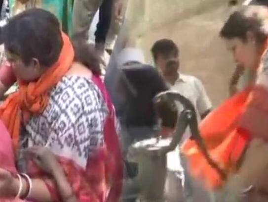 Smriti Irani draws water from handpump in fire-affected  fields in Amethi Purab Dwara village