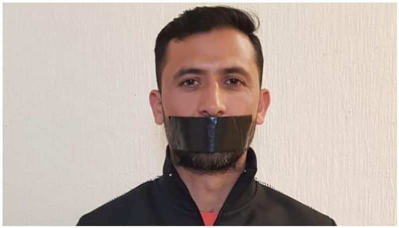 Junaid Khan with black tape on mouth