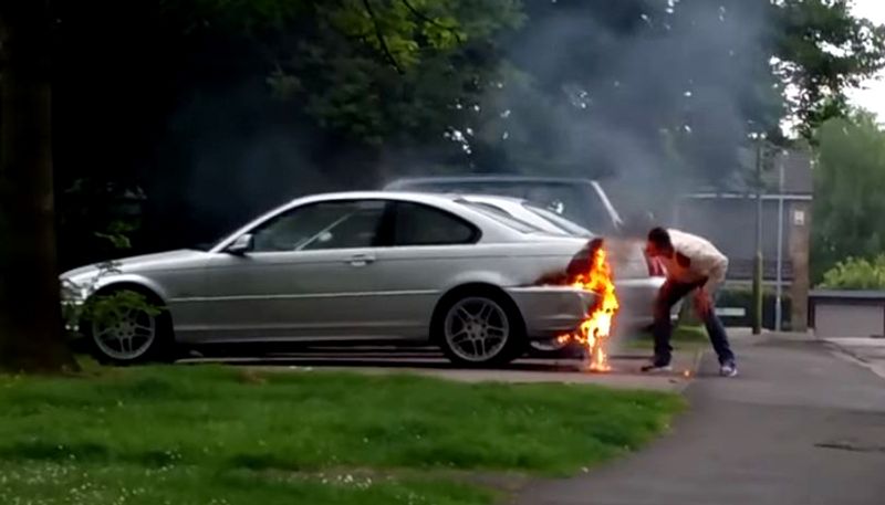 Owner Tries to Put Out Fire on BMW by Kicking, Blowing on the Flames