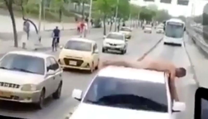 Wife humiliates cheating husband by making him lie naked on car in street