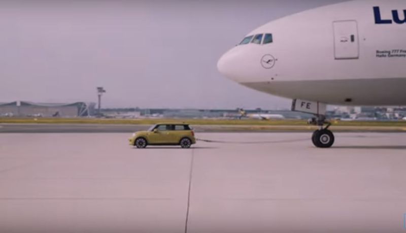 BMW Mini Cooper Electric car pull  Boeing 777 airplane