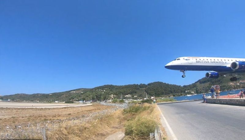 tourists attempts to take photos with landing aircraft in greece