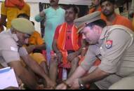 UP police officers are serving kawad yatris in Varanasi