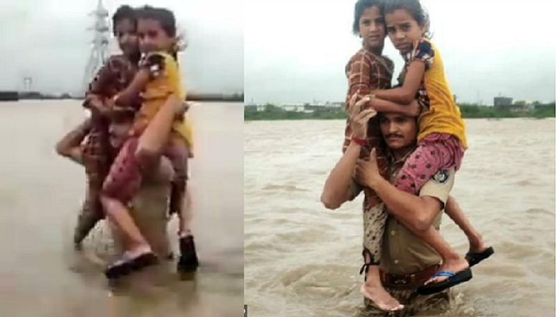 Gujarat floods Police constable Pruthvirajsinh Jadeja rescues two kids on his shoulders