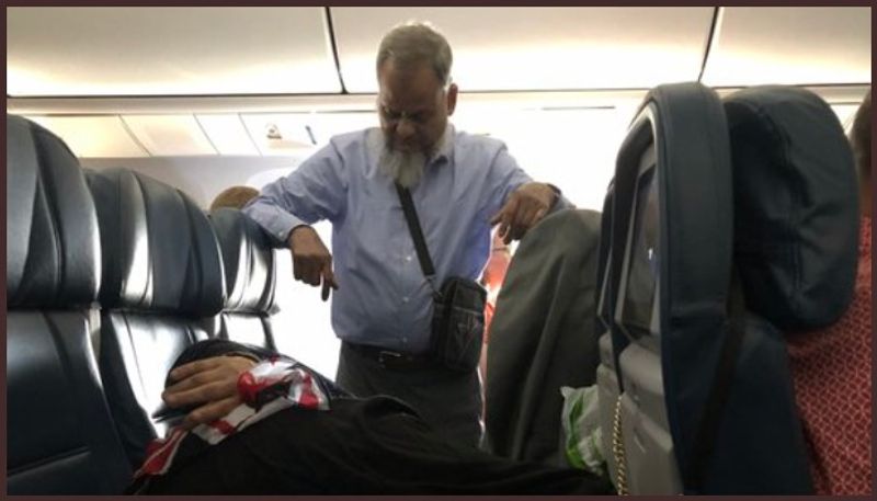 Viral pic of man standing for 6 hours on flight so wife can lie down divides Twitter