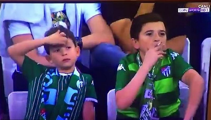 World fooled by child smoking in gallery during friendly match