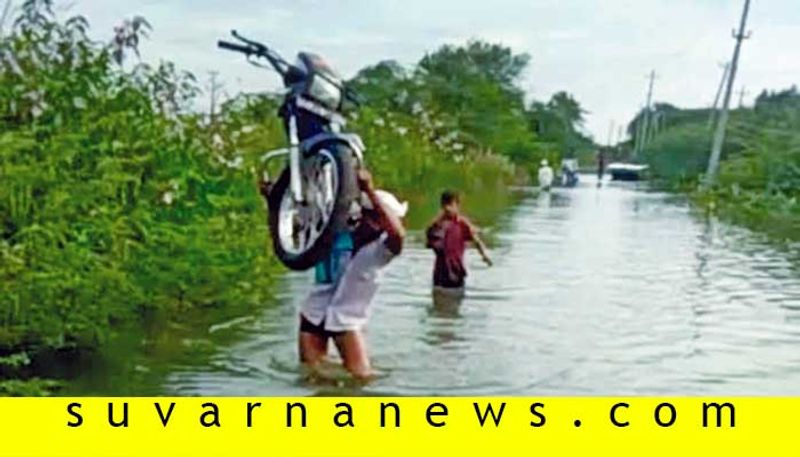 Youth carried bike in flood water in vijayapura