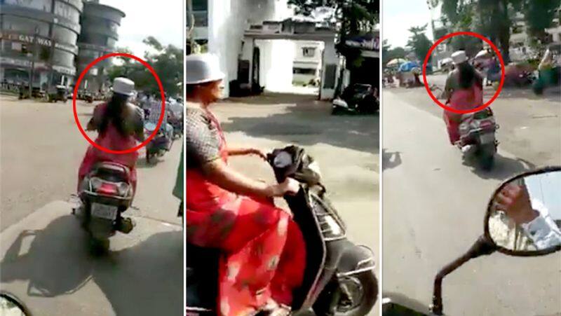 Woman Wear Metal Vessel in Place of Helmet and Riding Bike video..