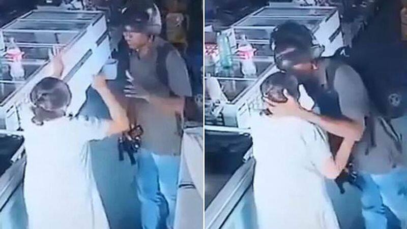 pharmacy robber takes mercy on elderly shopper and kisses