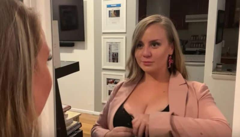 woman with a hidden camera on chest for campaign against breast cancer