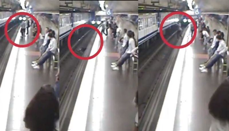 viral video goes women busy with mobile phone falling in front of train in Spain