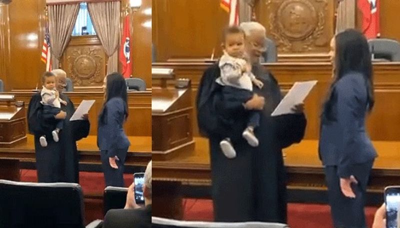 Judge holds baby while his mom takes oath to become lawyer