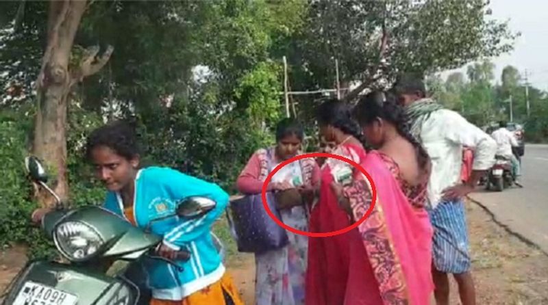 women workers distributes money to voters in hunsur