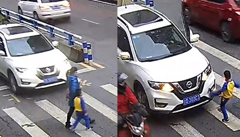 little boy kicks car and tells off driver after he knocks down mother on zebra crossing