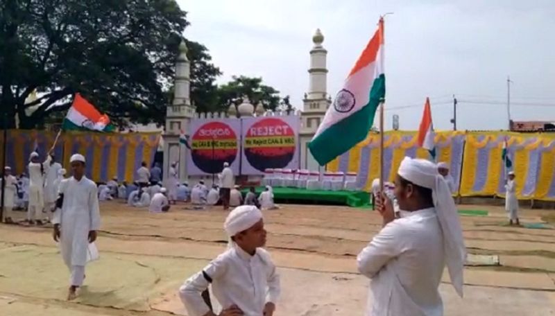 muslims offer prayer holding national flag tie black cloth to hand in mandya