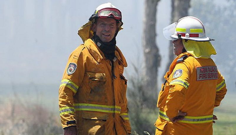 Former Prime Minister Of Australia Tony Abbott puts on his uniform and fights fires south of Sydney