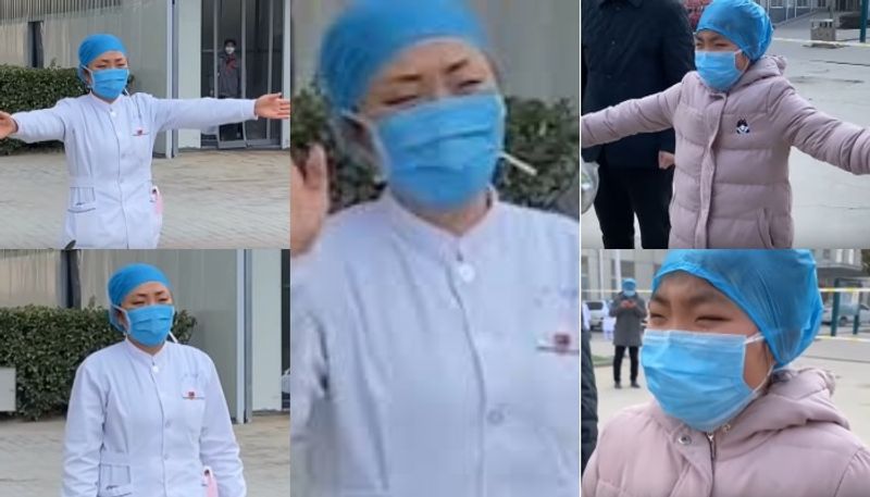 chinese nurse treating coronavirus patients gives daughter air hug