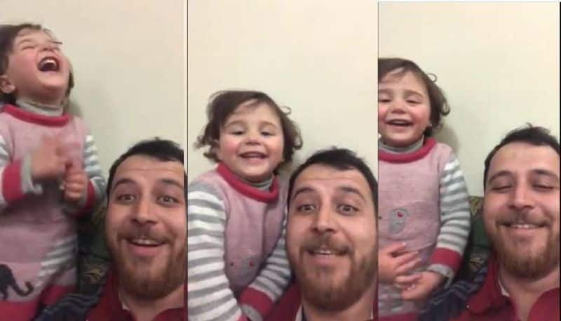 father makes daughter laugh distract from sounds of Bombing in Idlib Syria viral video