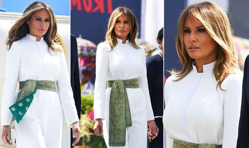 with breezy white jumpsuit and gold embroidered sash Melania Trump pays tribute to Indian textiles