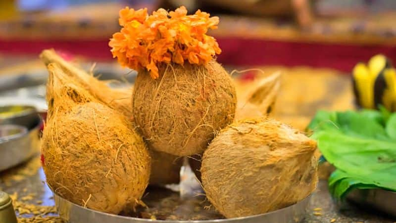 Why do hindus break coconut in the Temple?