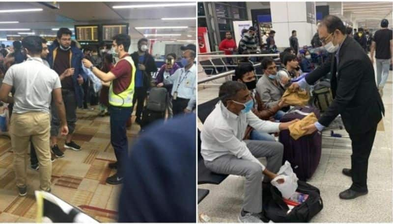 delhi airport staff providing food and masks to passengers