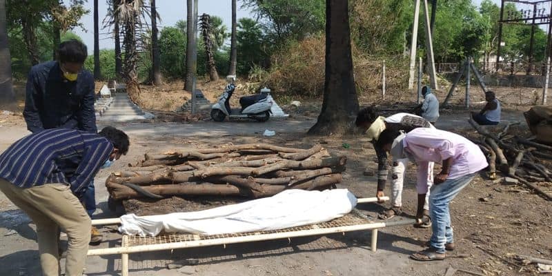 Helping hand activists perform last rites to a woman at Jagitial