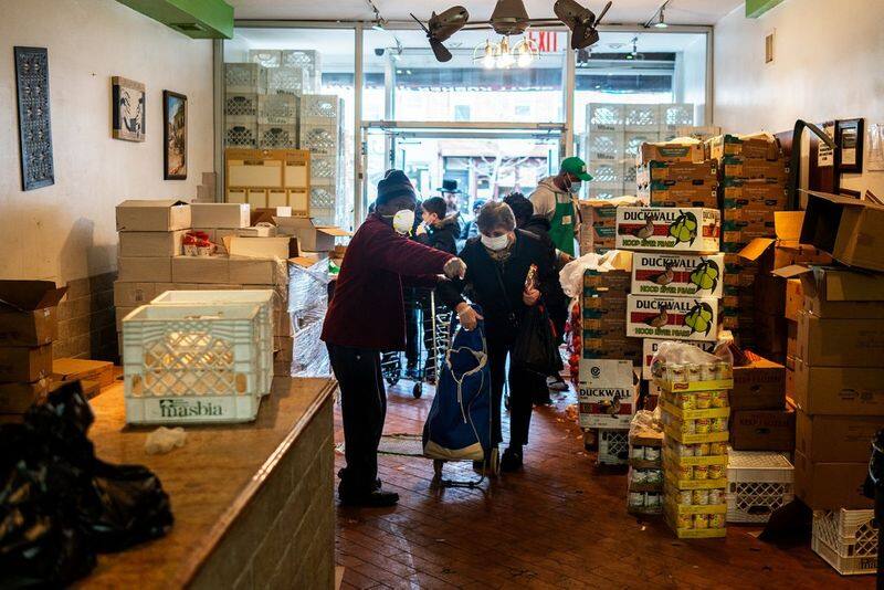 America Food Banks are over run people stand Mile ling line for food