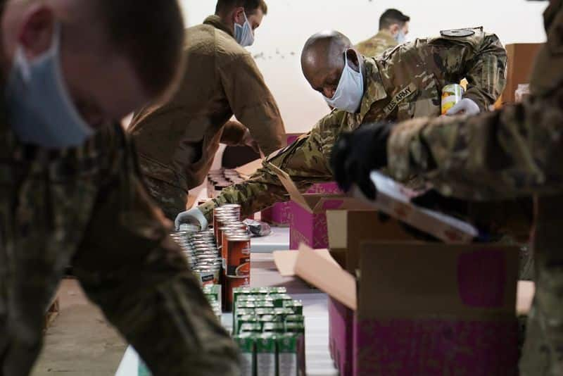 America Food Banks are over run people stand Mile ling line for food