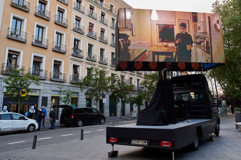 Residents entertain themselves with 'balcony cinema' amid lockdown in Madrid