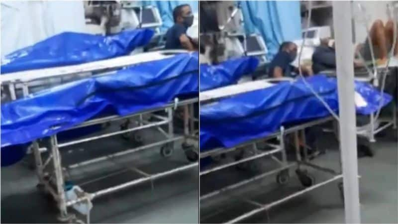 video shows bodies wrapped in plastic lying next to patients