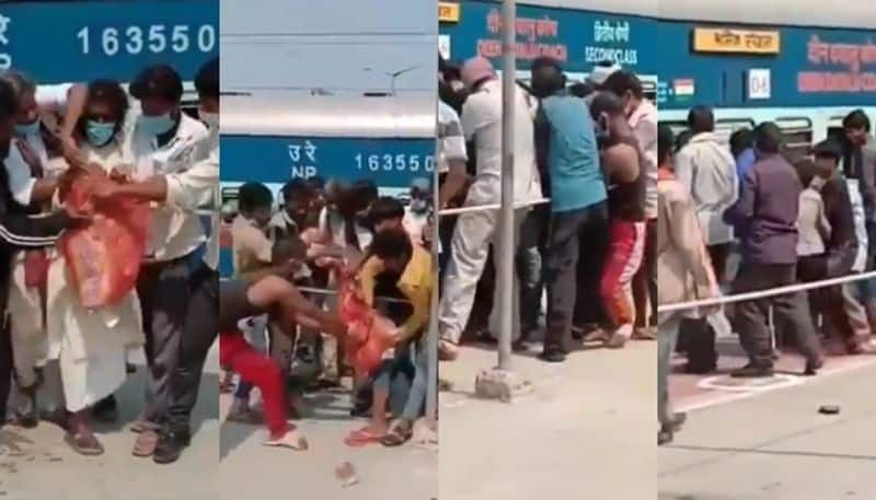 video shows migrant fighting over food packet at bihar