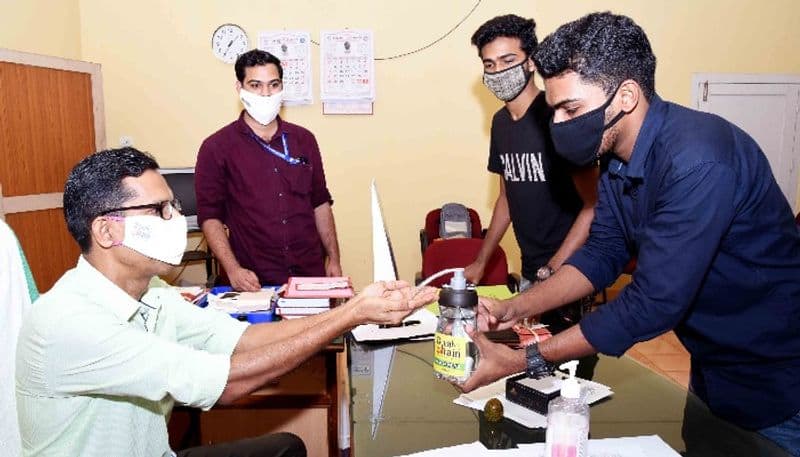 Engineering student with automatic sanitizer sprayer