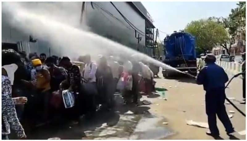 civic agency sprayed with a disinfectant on group of migrants in delhi