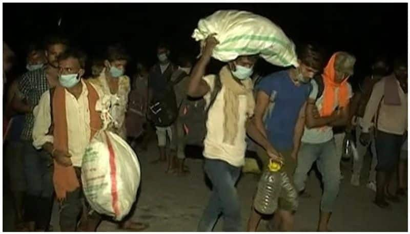 Hundreds of migrant workers crossing the Yamuna river on foot at night from Haryana to go home in Bihar