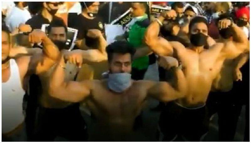 demanding the government allow gyms to reopen youth conducts push up strike