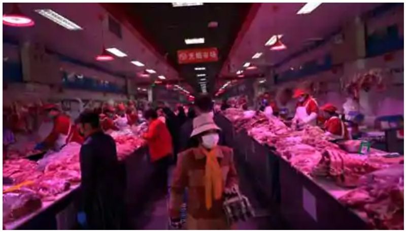 Beijing market shuts after coronavirus detected on salmon chopping board