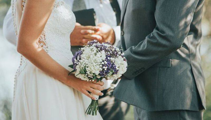 Awkward Groom grabs bride's buttocks while preacher prays at wedding; video goes viral