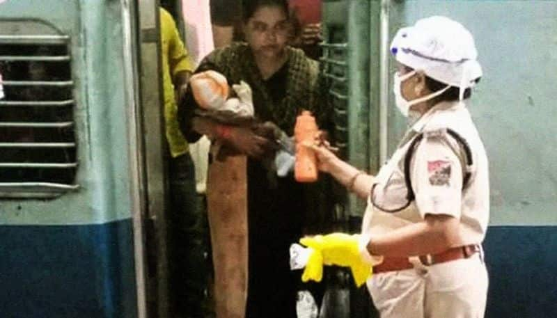 police women fetches milk from her house for hungry child shramik train