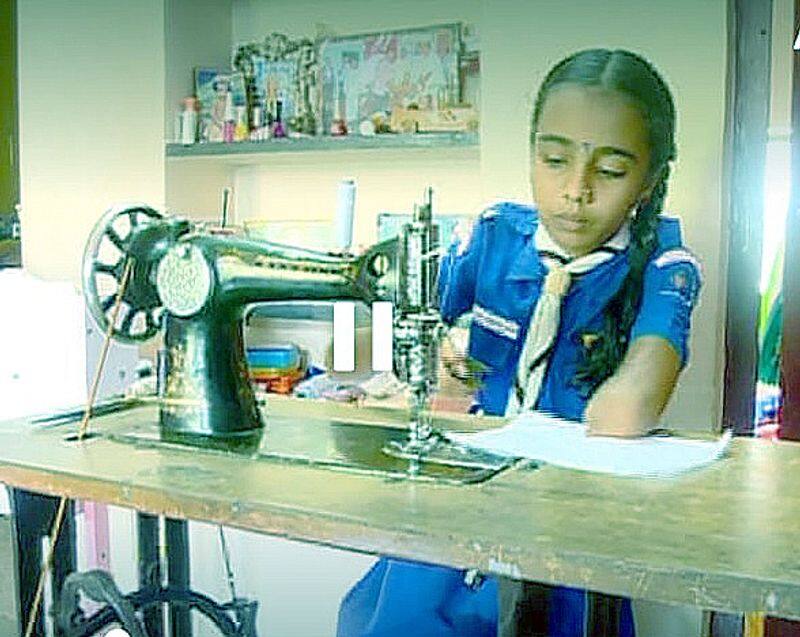 Physically challenged girl stitches mask at home