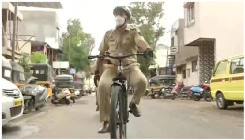 police officer conduct patrolling in containment zones on cycle