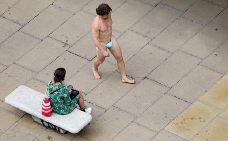 Naked Man walks London shopping street only mask to cover his nudity